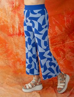 A jaunty, bold patterned pant is a cheat code to a happy mood!! Slits at the back will reveal your calves and create extra styling points for this groovy design. Get matchy-matchy and pair them with our Aja ‘Shasha’ Top or Shasha Cardigan. HIGH/LOW PANTS WITH BACK SLIT IN 'DISCO LAVA' PATTERN 50% POLYESTER, 50% RAYON STYLE# M3881 Available sizes: S/M, M/L Low Pants, Lava Pattern, Groovy Design, Cheat Code, Happy Mood, Meet The Team, Ketchup, High & Low, High Low