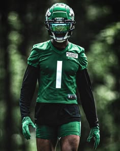 a football player wearing green and black uniform