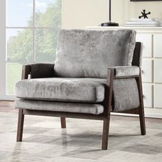 a gray chair sitting on top of a wooden floor