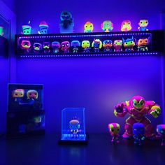 the room is lit up with neon lights and various toy figurines on display