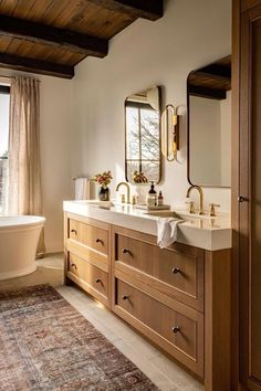 a large bathroom with two sinks and a tub