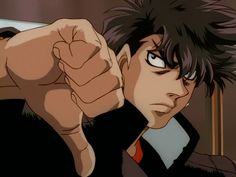 an anime character pointing at the camera with his fist out and one hand in front of him