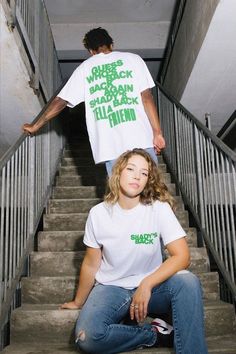 two people are sitting on the stairs and one is wearing a t - shirt that says, where's jack green?