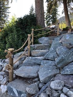 there is a rock and wood fence on this hill