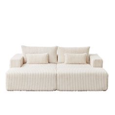 a white couch sitting on top of a white floor