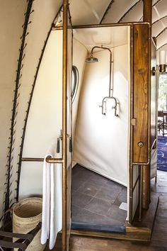 the inside of a tent with an open door and some towels hanging from it's sides