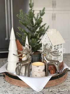 a tray with christmas decorations and candles on it