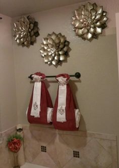 two red towels hanging on the wall in a bathroom