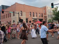 a group of people are dancing in the street