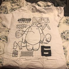 a white t - shirt with an image of a turtle and other things on it