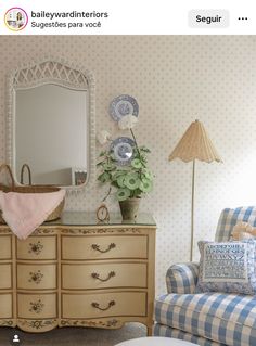 a room with a chair, dresser and mirror