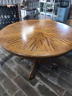 a wooden table sitting on top of a brick floor