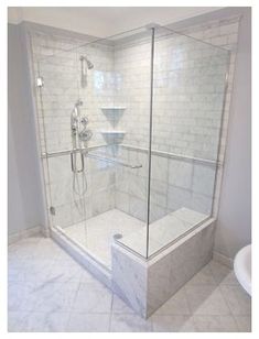 a bathroom with a walk in shower next to a sink and bathtub on the floor