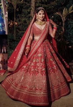 a woman in a red and gold bridal gown