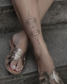 a woman's foot with a tattoo on it