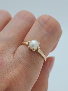 Total Weight -  2.7 grams Stone - 6mm Size - 7 Excellent vintage condition.  *Cleaned & Disinfected with Ultrasonic & Alcohal. *Lightly polished and Carefully inspected.  All Vintage Jewelry from -Lories Jewel- are from reputable vintage markets   Ships in Gift Box Classic 14k Gold Solitaire Pearl Ring, Classic 14k Gold Pearl Ring With Round Band, Classic 14k Gold Pearl Ring, Classic Pearl Ring With Polished Finish, Classic Pearl Ring With Polished Round Cut, Classic Oval Pearl Ring In 14k Gold, Classic 14k Gold Oval Pearl Ring, Classic Round Pearl Ring For Anniversary, Classic Round Cut Polished Pearl Ring