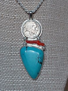 One of a kind, handcrafted, sterling silver pendant with turquoise, red coral, and 1936 Indian head nickel. Measures about 81mm X 30mm. Chain not included. Traditional Turquoise Pendant Necklace, Traditional Turquoise Necklace With Large Sterling Silver Pendant, Handmade Turquoise Medallion Necklace Gift, Handmade Turquoise Medallion Necklace As Gift, Handmade Turquoise Medallion Necklace For Gifts, Red Southwestern Turquoise Necklace For Gift, Traditional Sterling Silver Turquoise Necklace Gift, Traditional Turquoise Necklace In Sterling Silver For Gift, Indian Head