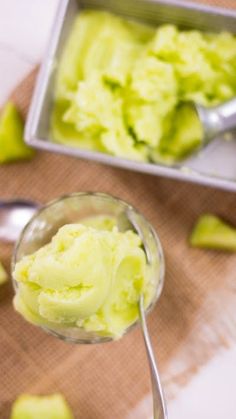 a spoon full of ice cream next to a pan filled with cucumber slices