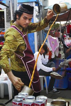 a man pouring something out of a can