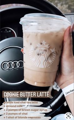 a person holding up a drink in their hand with the caption cookie butter latte