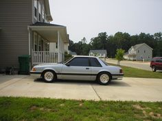 a silver car parked in front of a house