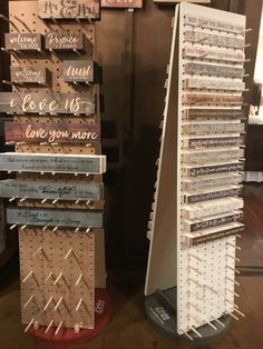 two wooden signs are stacked on top of each other in the shape of a triangle