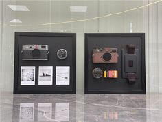 two black frames with pictures and cameras on them