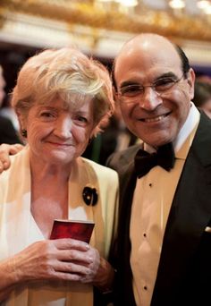 an older man and woman are posing for the camera