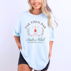 Par Then Bar Ladies Golf Club" Comfort Colors T-Shirt - The Perfect Tee for Women Who Love Golf!  Calling all golf-loving ladies! This Par Then Bar Ladies Golf Club T-Shirt is the perfect mix of sporty and stylish, ideal for hitting the green or celebrating with your golfing crew after a great round. Whether you're a dedicated golfer or just love the lifestyle, this tee is a must-have addition to your wardrobe. Soft, durable, and available in a wide range of sizes, it's great for women who want Graphic Tee Golf Tops With Short Sleeves, Graphic Tee Tops For Golf With Short Sleeves, Graphic Tee Tops For Golf, Pre-shrunk Short Sleeve Tops For Golf, Graphic Tee Golf Tops With Crew Neck, Graphic Tee Crew Neck Tops For Golf, Golf Lover Gifts, Ladies Club, Golf Tee