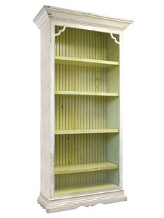 a white bookcase with shelves on the top and bottom, painted in light green