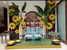 a decorated stage set up with flowers and chairs