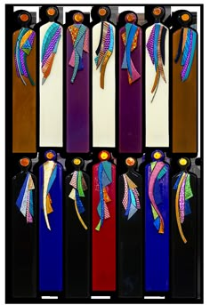 six pieces of glass with different colors and designs on them, each featuring an individual's head