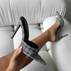 Feel fresh in these grey monogram heeled mules! Featuring a pointed toe, front strap, and a stiletto heel. Style these grey monogram heeled mules with a mini dress and statement accessories. - Heel measures approximately 4.25 inches/ 10.8cm- Faux leather upper- Model wears UK 6 / EU 39 / US 8- Fits true to size Gray Open Toe Heels For Evening, Chic Gray Heels For Summer, Chic Gray Summer Heels, Elegant Gray Spring Heels, Trendy Pointed Toe Mules For Night Out, Trendy Gray High Heel Heels, Trendy Gray High Heels, Gray Heels For Spring Party, Gray Fitted Heels For Evening