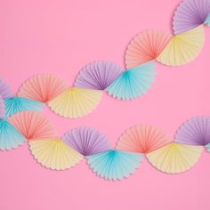 colorful paper fan garland on pink background