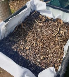 a composting bin filled with mulch and wood chips