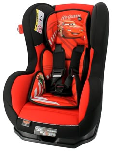 the child's car seat is red with black trim and features cars on it