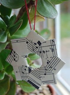 an ornament hanging from a potted plant with sheet music notes on it