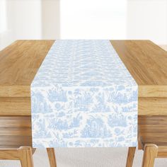 a wooden table topped with a blue and white table cloth