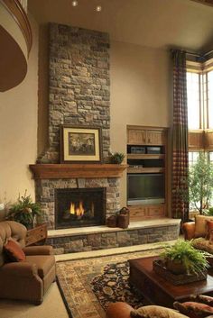 a living room filled with furniture and a fire place in the middle of a room