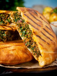 some food that is cut in half and sitting on top of a plate with the words lamb araves, lebanese stuffed pitas