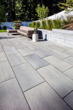 an outdoor patio with seating and trees in the background