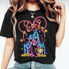 a woman wearing a mickey mouse t - shirt