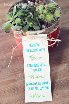 a potted plant sitting on top of a wooden table next to a sign that says thank you for helping me to grow and teaching me all that you