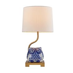 an owl lamp with a white shade on it