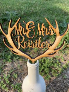 a wooden sign that says mr and mrs rester on top of a bottle in the grass