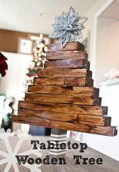 a wooden christmas tree sitting on top of a table