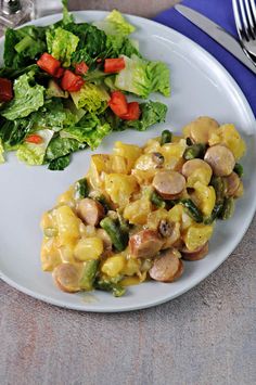 a white plate topped with food next to a salad