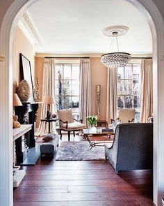 a living room filled with furniture and a chandelier