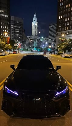 a black sports car parked on the street at night