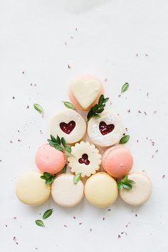 some cookies are arranged in the shape of a pyramid with hearts and flowers on top